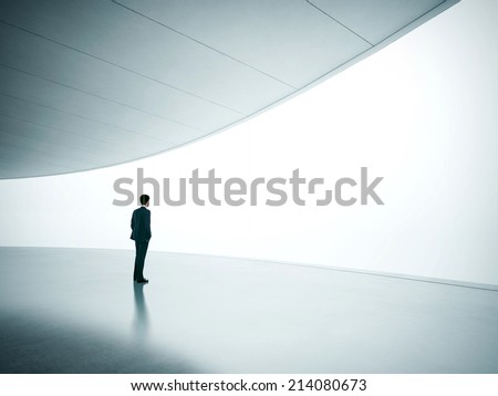 Businessman looking at wide shining screen Royalty-Free Stock Photo #214080673