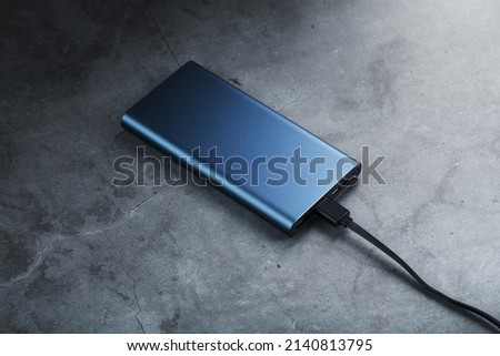 Portable External Battery Power Bank blue with USB Cord Royalty-Free Stock Photo #2140813795