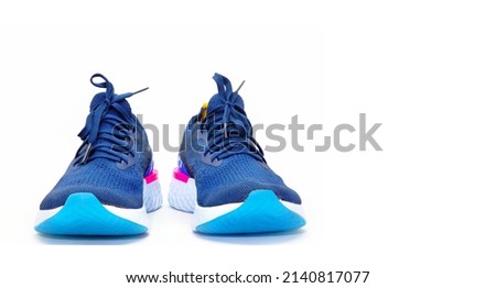Pairs of blue sport shoes for running on white background