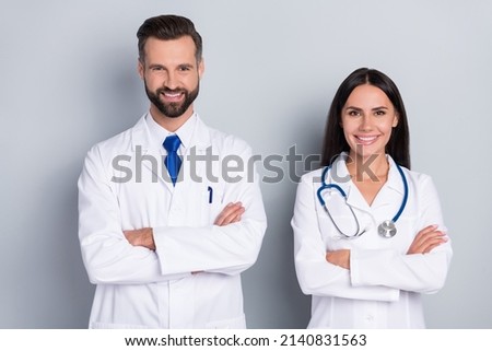 Photo of two positive intelligent therapist folded arms toothy smile look camera isolated on grey color background Royalty-Free Stock Photo #2140831563