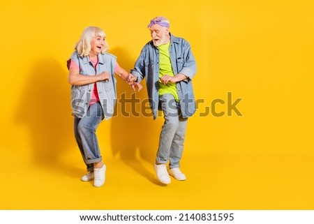 Photo of sweet adorable husband wife wear jeans shirts dancing empty space isolated yellow color background