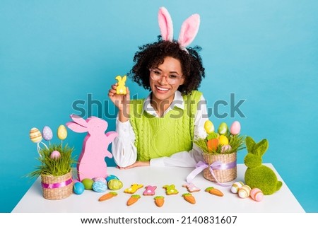 Photo of cute adorable lady celebrate spring holiday hold little bunny craft isolated on blue color background