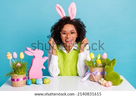 Photo of beautiful charming woman raise fist winner celebrate spring holidays isolated on blue color background