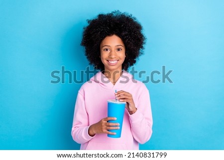 Portrait of attrctive trendy cheerful girl drinking beverage free time rest isolated over vibrant blue color background Royalty-Free Stock Photo #2140831799
