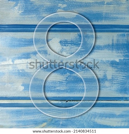 number eight on wooden blue background photo.