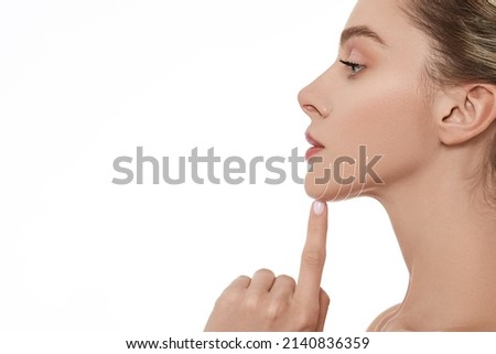 Beautiful woman with perfect skin with lifting arrows on chin line, isolated, side view. Cosmetology procedure for beautiful and elastic face contour Royalty-Free Stock Photo #2140836359
