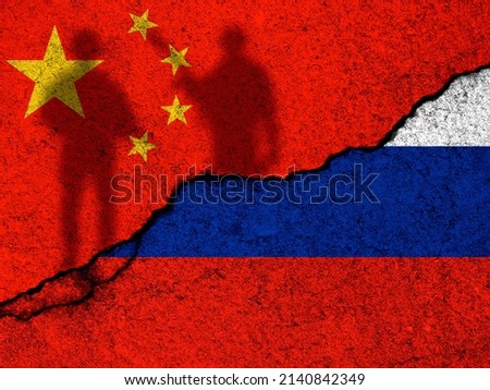 China and Russia relationships background. Country flags painted on cracked concrete walls. Sanction concept photo