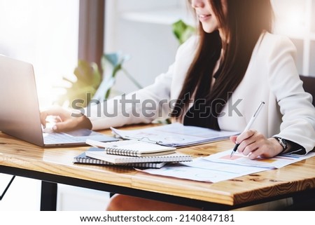 Investment concepts, businesswomen use document and computers to analyze stock markets, quantitative data collection, financial statement analysis, profitability through internet technology. Royalty-Free Stock Photo #2140847181
