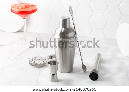 Cocktail equipment, barman, bartender tools set. Shaker, strainer on white background. Orange coctail. Royalty-Free Stock Photo #2140870251
