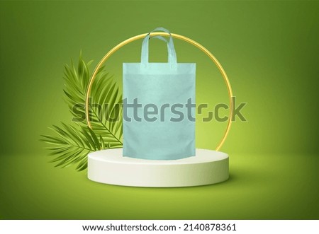 Environment Friendly white shopping bag isolates on the product podium with green tropical palm leaves and a golden round arch on a green background. I’m not plastic. DISSOLVE IN HOT WATER