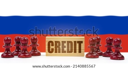 National concept. Against the background of the flag of Russia, pawns and a sign with the inscription - credit