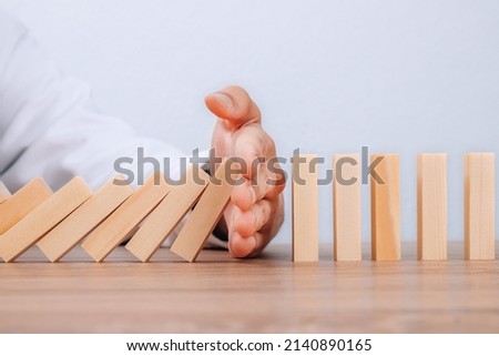 hand controlling domino effect pollution, business concept Royalty-Free Stock Photo #2140890165