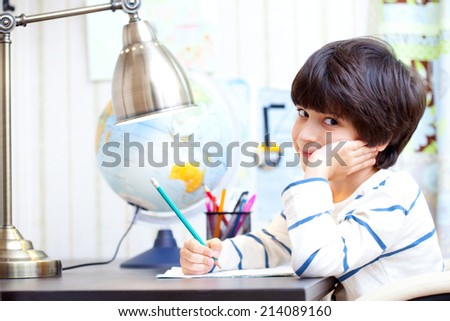 schoolchild doing homework at his desk