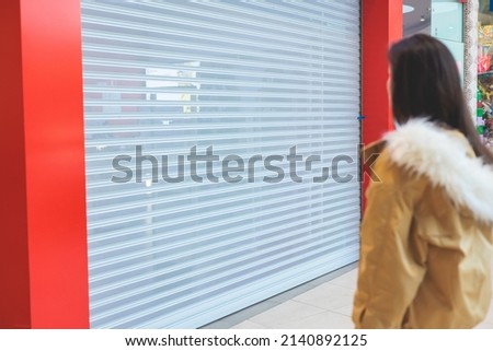 Stores show case in shopping mall closed due to sanctions, boycott and embargo, mass market cloth shops work stoppage with closed storefronts, retail business suspension and brands leaving market