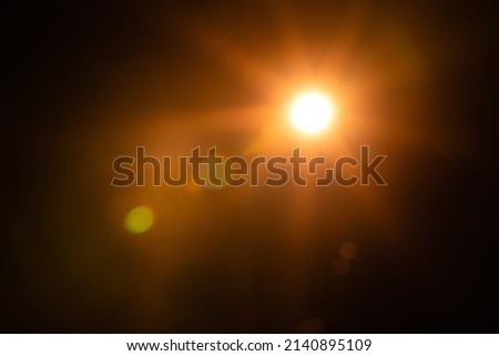 Solar lens flare on black background