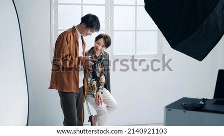 Male photographer and female model taking a picture