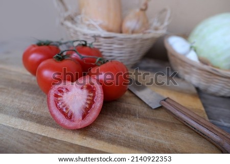 vegetable stocks are laid out on wooden shelf, ripe red tomatoes, head of cabbage in basket, garlic, pumpkin, onions, old dishes, concept of ingredients for cooking homemade food, vitamin products