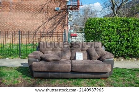 A old leather couch discarded on street side for free to be taken away 