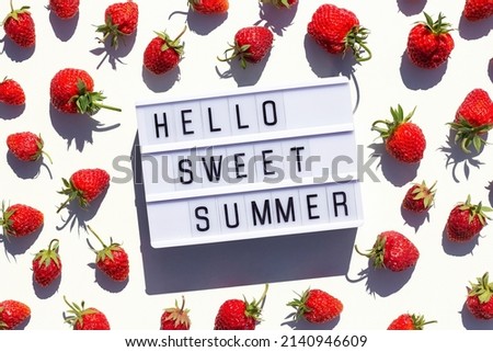 Hello Sweet Summer text on light box and strawberry on white background. Creative concept Summer time. Top view, Flat lay, greeting card.