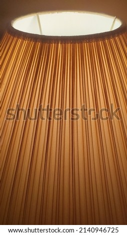 Photo out of focus brown striped bedroom lampshade