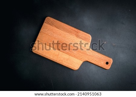 wooden cutting board on an empty black wooden board,food menu concept