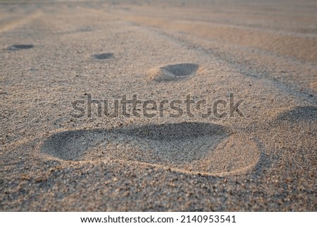 Inspiring footprints on charades beach background pictures in the light of sunset