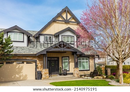 Luxury house in Vancouver, Canada. Big luxury house with a patio on sunny day. Selective focus, nobody.