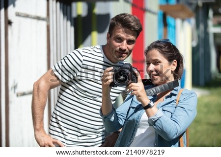 trendy couple in the city taking photos