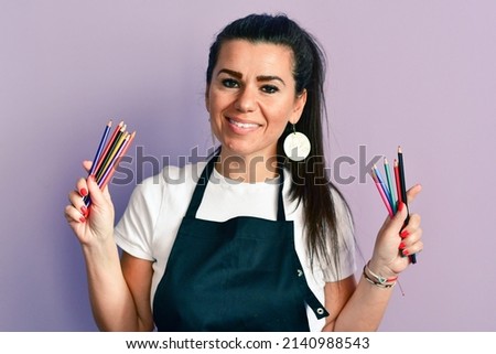 Hobbies, creativity and art concept.  Smiling   Beautiful Woman   inviting to Draw picture Together, creative female spend Leisure at home with fun and joy holding Colored Pencils
