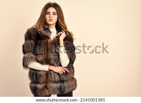 Winter elite luxury clothes. Female brown fur coat. Fur store model posing in soft fluffy warm coat. Pretty fashionista. Fur fashion concept. Woman makeup and hairstyle posing mink or sable fur coat Royalty-Free Stock Photo #2141001381