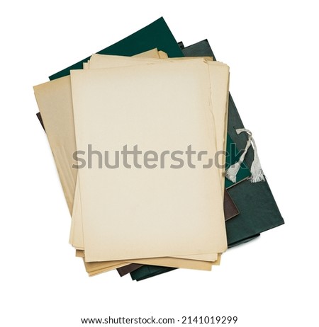 Old yellowed sheets of paper lie in a pile on a paper folder.