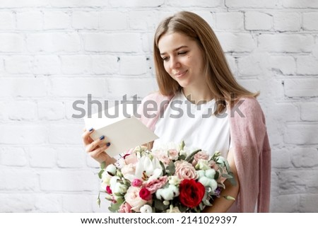 portrait of nice attractive lovely pretty cheerful girl getting receiving congrats card birthday greetings big bouquet flowers