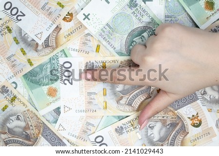 Polish banknotes. Polish currency with a hand pointing number arranged in a pattern. Illustrates cash flow and money business