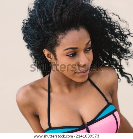 Beautiful young woman close up portrait wearing bikini relaxing on South Beach. Miami, florida.