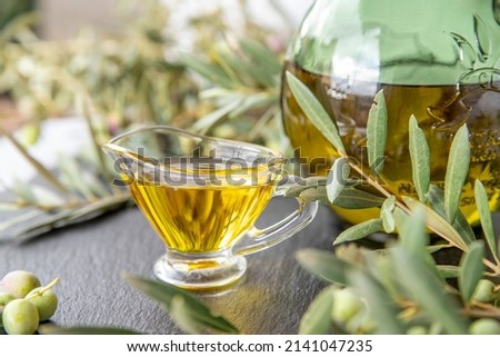 green olives with olive oil on a dark background