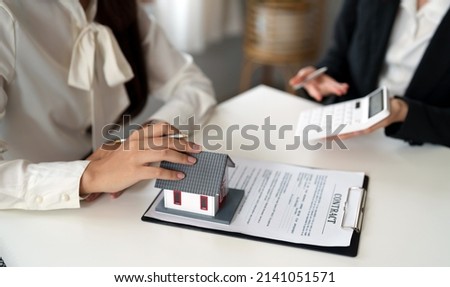 Real estate agent or bank officer describes the loan interest to the customer with home purchase contracts or on office loans and interest rates