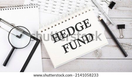 HEDGE FUND . Text written on a notepad with office tools and documents.