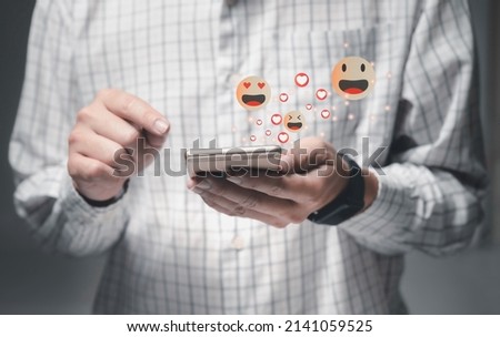 Social media and digital online concept,with notification icons of like, message, email, comment and star above smartphone 
