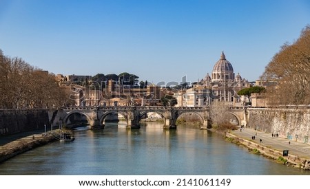 A picture of the St. Angelo Bridge, the St. Peter's Basilica and the Tiber river.