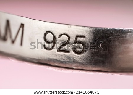 Real silver stamp, 925 number mark on a real silver ring, indicating the purity of the precious metal in the jewellery. Detail macro shot Royalty-Free Stock Photo #2141064071