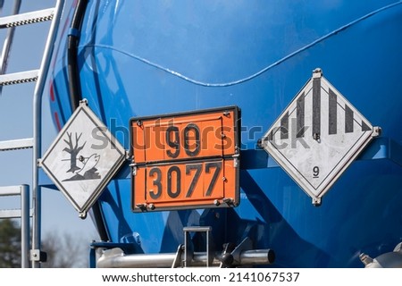 Various dangerous goods signs on the tank of a tank truck