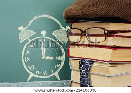 Time of schoolwork, teacher before chalk drawing of alarm clock