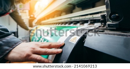 Graphic design and  advertising concept. Large format plotter, close up Royalty-Free Stock Photo #2141069213