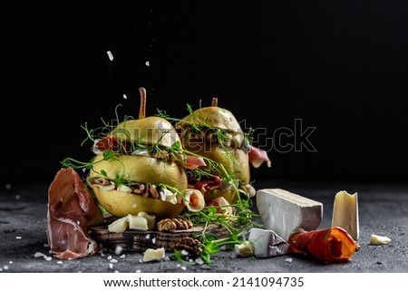 Pear appetizer with jamon, prosciutto ham and camembert cheese. Italian antipasto. banner, menu, recipe place for text.