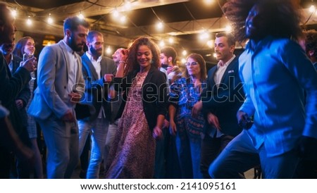 Beautiful Carefree Friends are Dancing Together and Celebrating an Evening Event at a Party . Diverse Multiethnic Young Adult People Have Fun at a Corporate Party in a Restaurant. Royalty-Free Stock Photo #2141095161