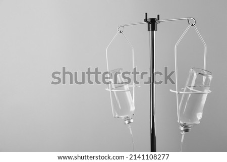 IV infusion set on light grey background. Space for text