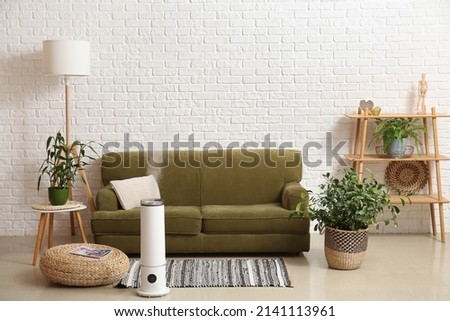 Interior of stylish living room with humidifier Royalty-Free Stock Photo #2141113961
