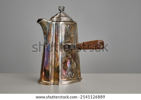 Vintage teapot on a light background and gray table.  Selective focus