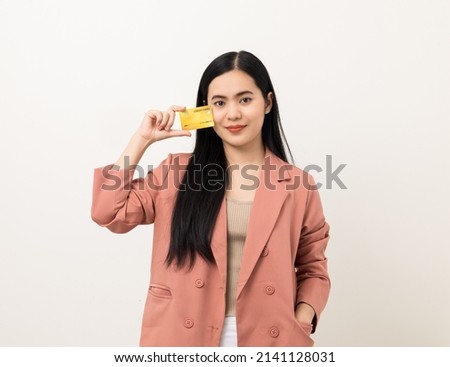 Portrait beautiful asian women in pink fashion suit standing pose holding credit card to shopping payment. Attractive Happy businesswoman with creditcard.