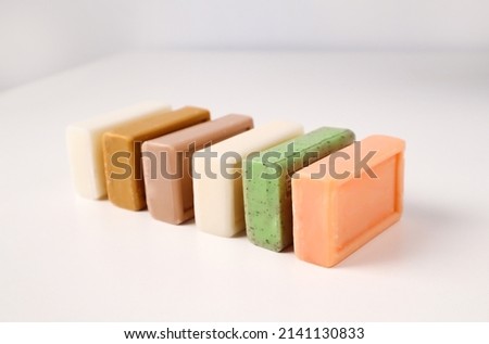 Multicolored bars of handmade soap from natural materials on a white background Royalty-Free Stock Photo #2141130833